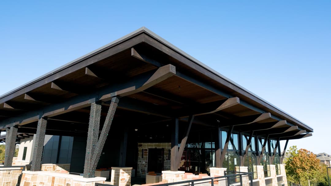 Modern architectural building with a striking roof design and natural stone accents.