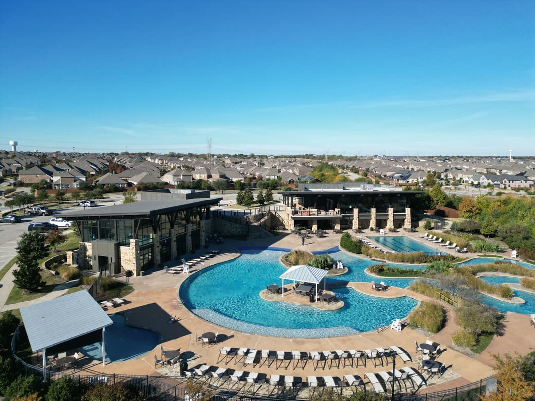 Resort-style swimming pool and modern facilities surrounded by scenic landscaping.
